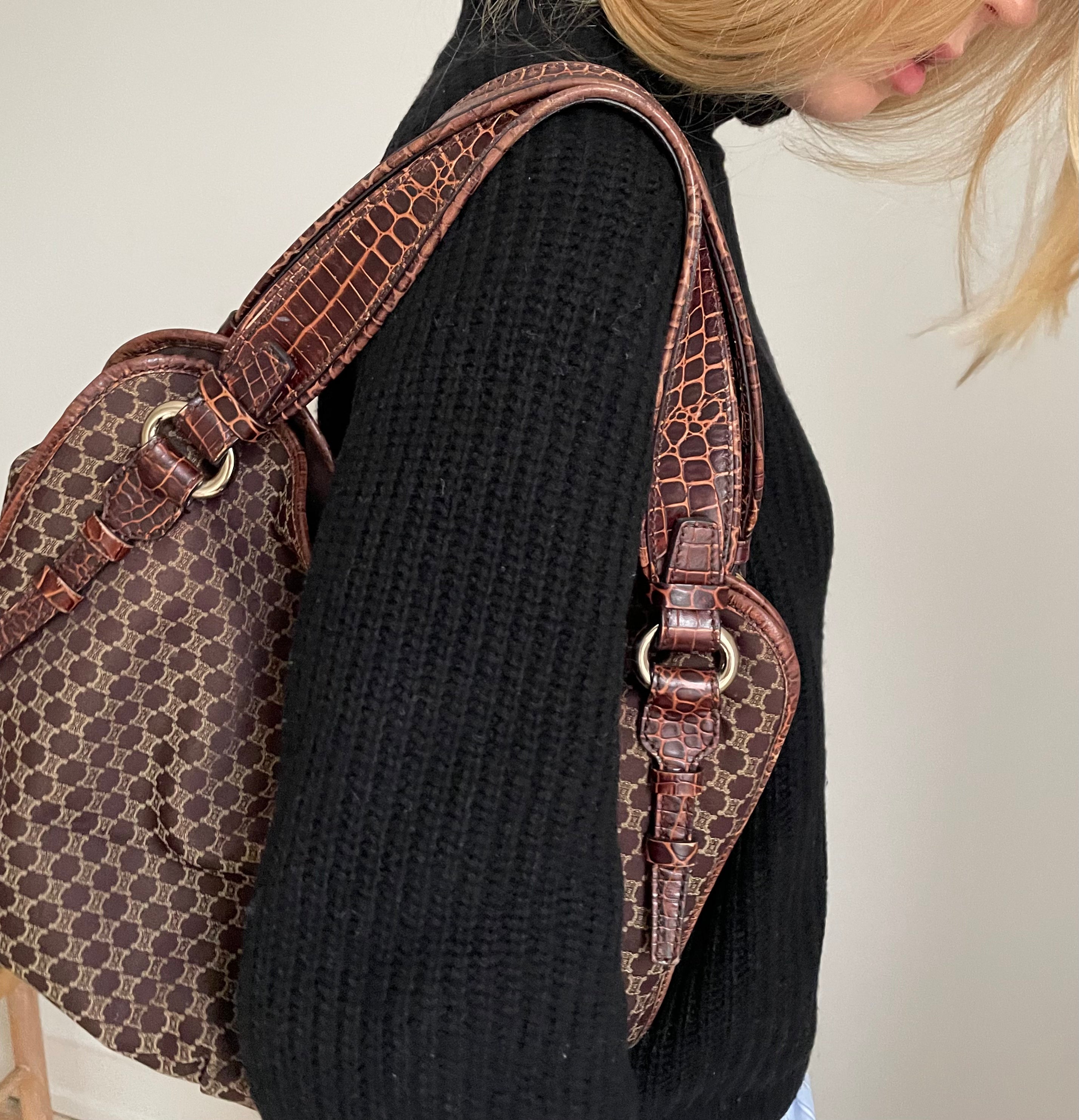 This is a Celine Macadam Bitter Sweet handbag, showcasing the brand's iconic macadam pattern. The bag features a combination of brown canvas and croc-embossed leather details, accentuated by gold-tone hardware.&nbsp;