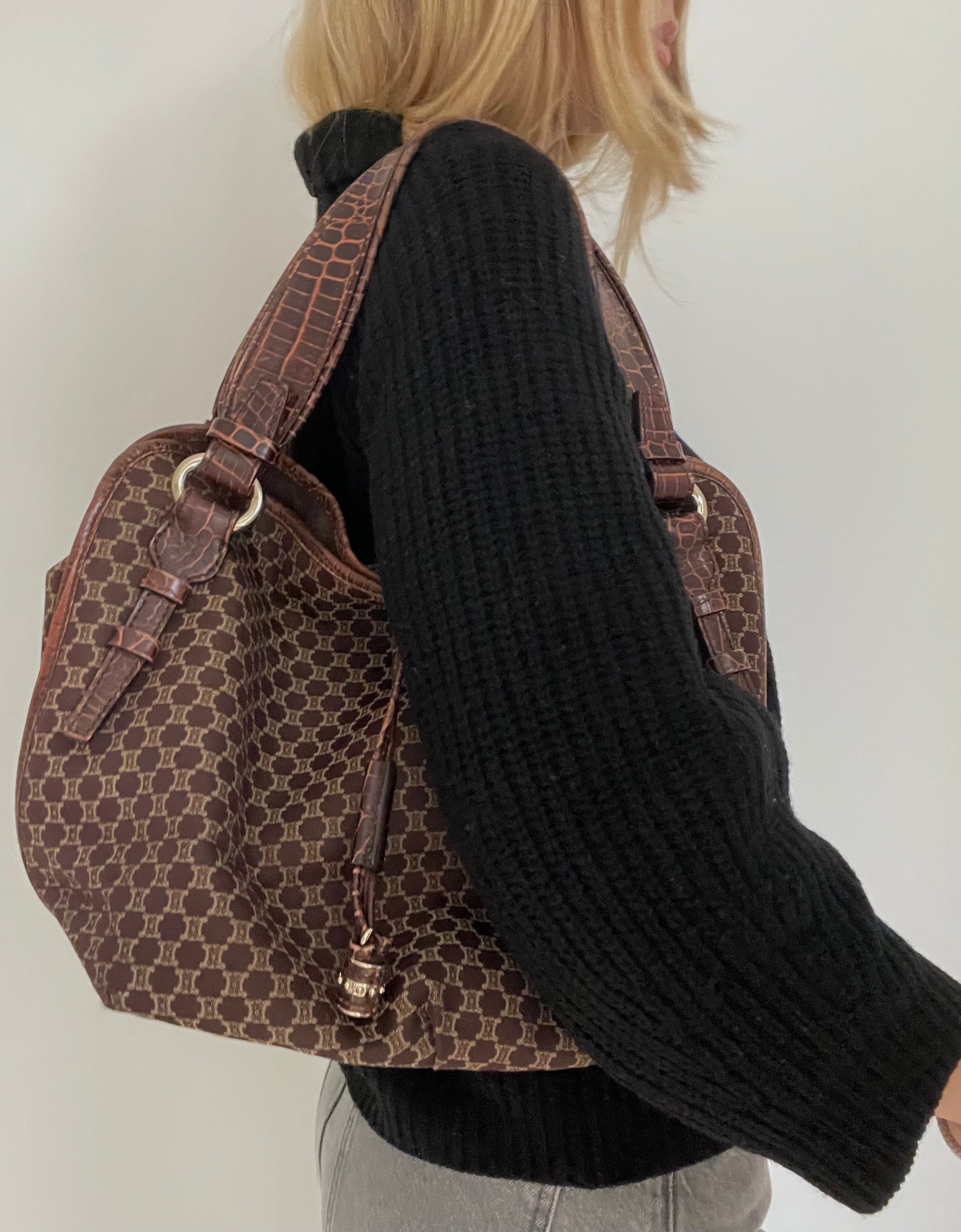 This is a Celine Macadam Bitter Sweet handbag, showcasing the brand's iconic macadam pattern. The bag features a combination of brown canvas and croc-embossed leather details, accentuated by gold-tone hardware.&nbsp;