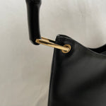 Vintage Gucci Bamboo bag with black handle and gold hardware.