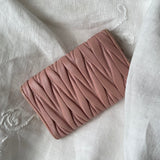 Miu Miu wallet in soft pink leather with a signature matelassé pattern.