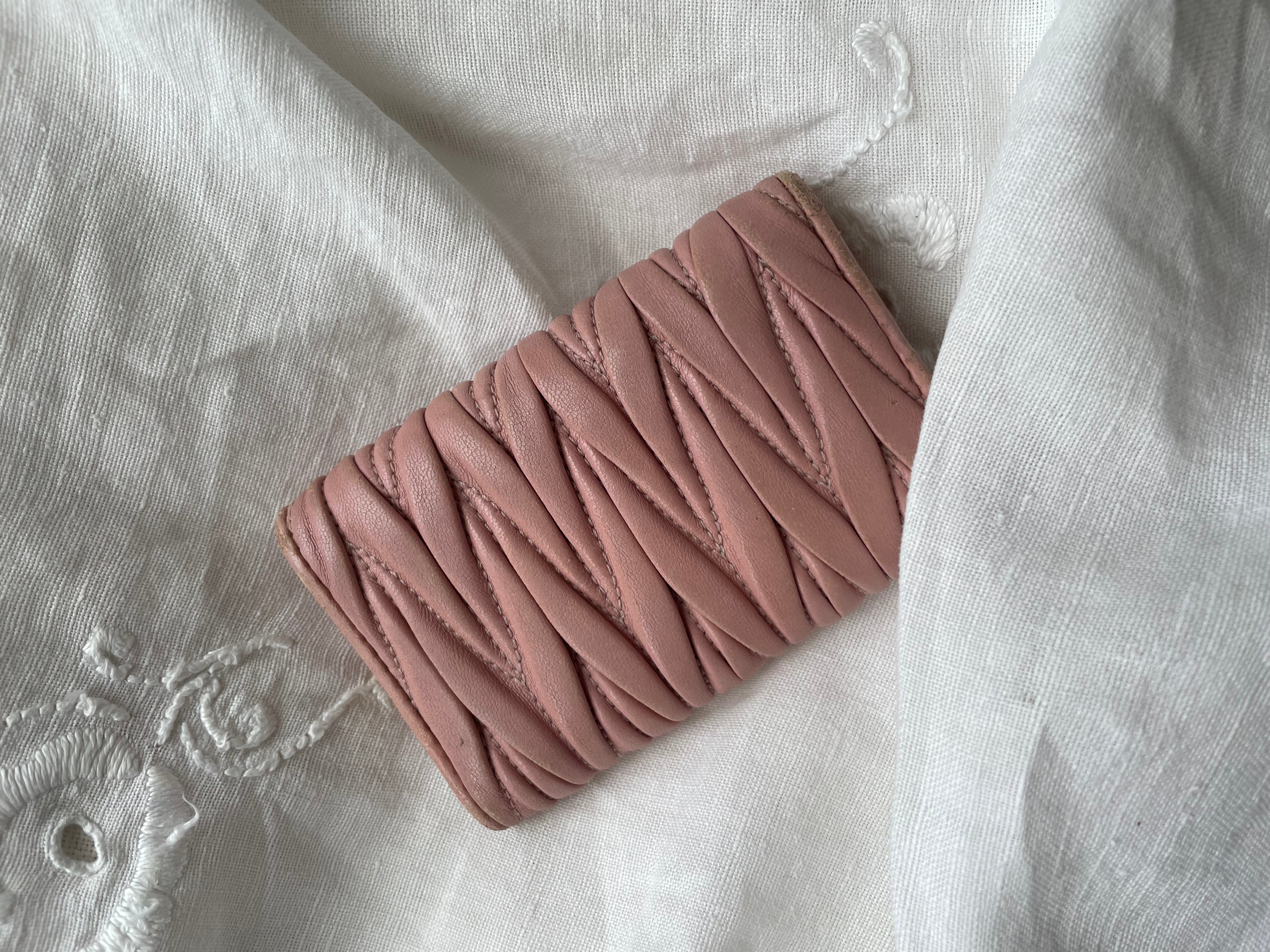 Miu Miu wallet in soft pink leather with a signature matelassé pattern.