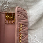 Miu Miu wallet in soft pink leather with a signature matelassé pattern.