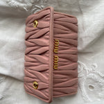 Miu Miu wallet in soft pink leather with a signature matelassé pattern.