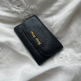 Miu Miu wallet in soft black leather with gold-colored hardware and room for 5 keys. The condition is rated 8/10, as one of the six key locks is missing, despite the wallet being in great overall condition.